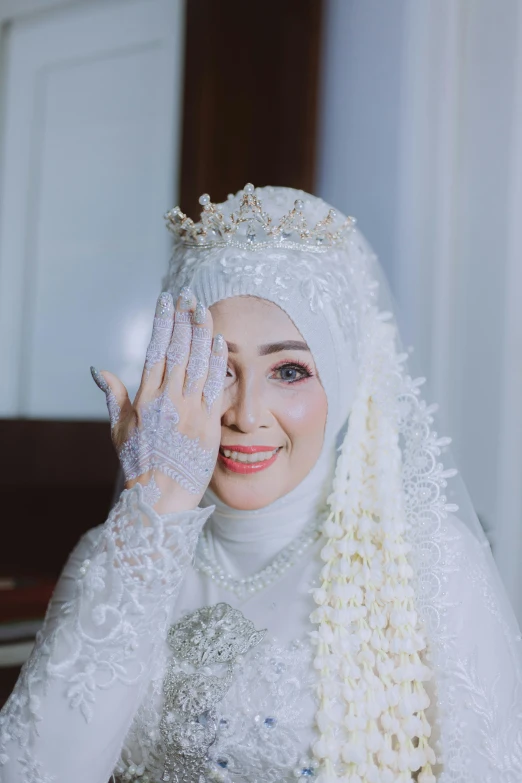 an oriental woman in traditional white and silver clothes