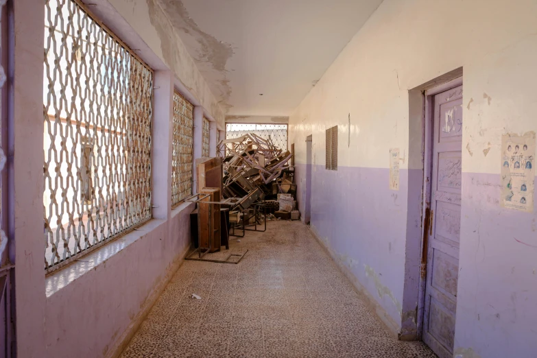 a long corridor with two doors and trash cans