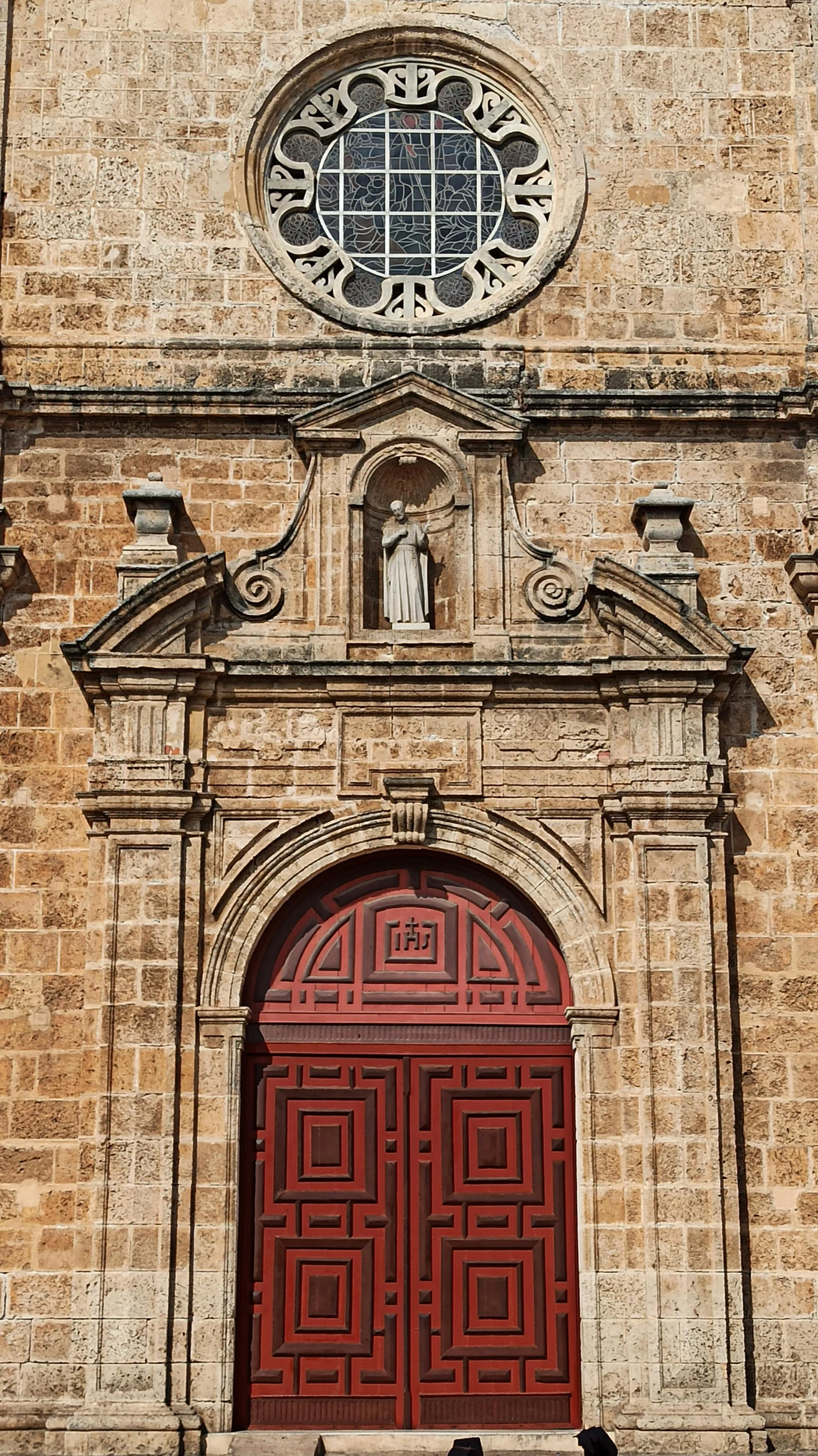 a tall building with a red door and a window