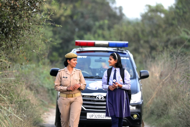 two people standing in the middle of a road