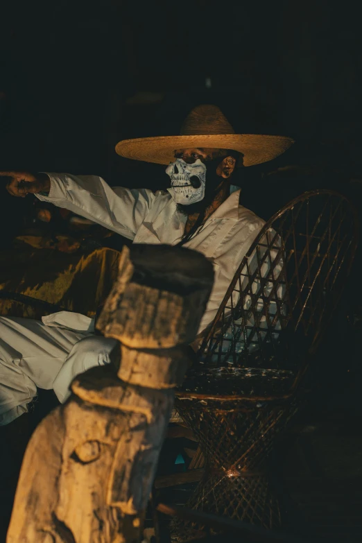 a costumed man in white and black sitting on a chair