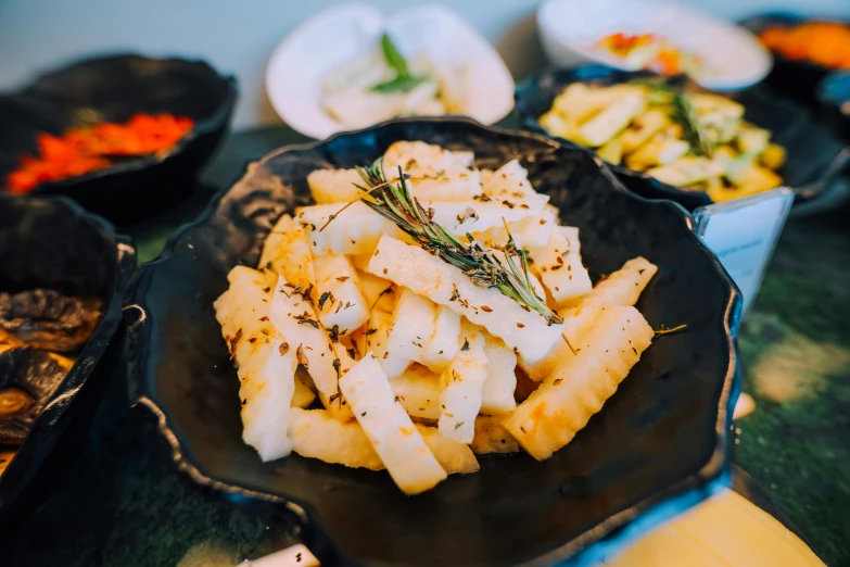 a plate filled with fries and other side dishes