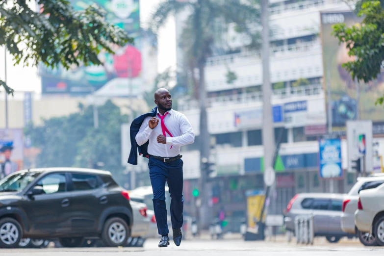 man in the middle of a busy city street walking with backpack