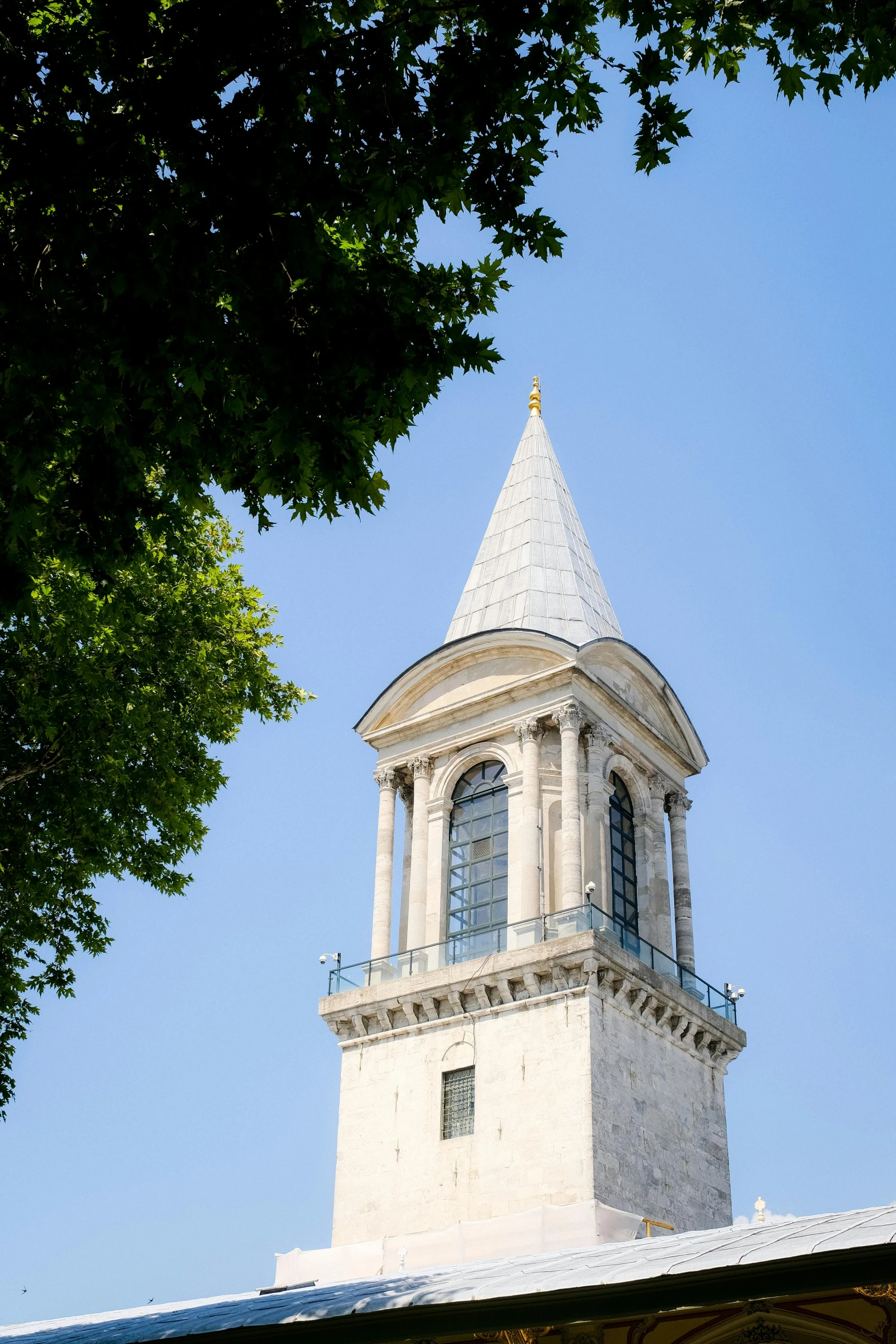 a tall clock tower with a weather vein