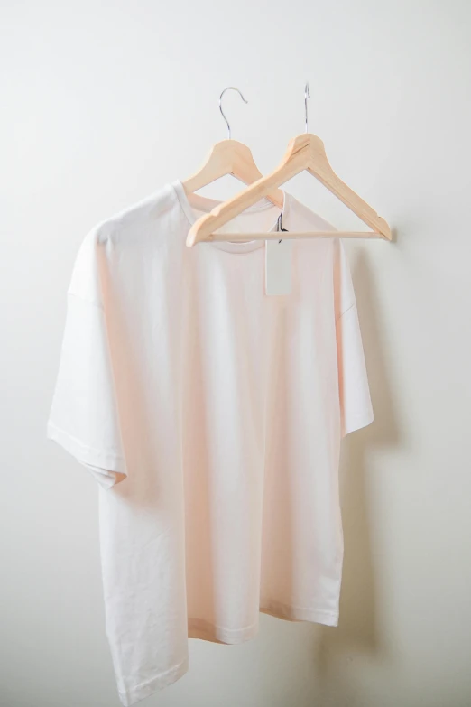 two shirts on a hanger and a t - shirt hanging