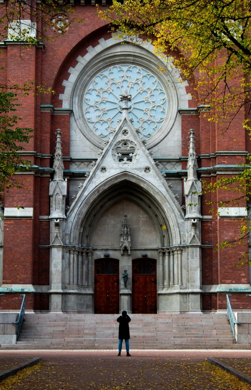 there is a man standing in front of a church