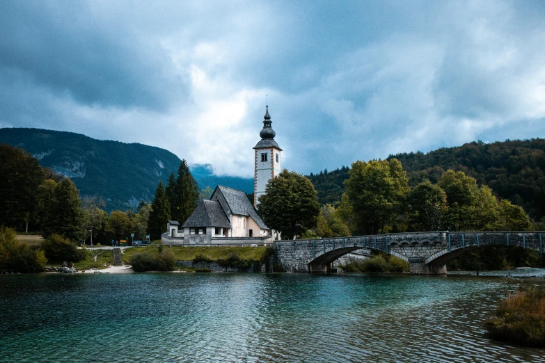 a scenic view of the church along a river