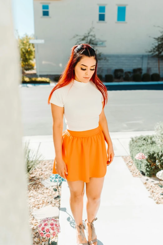 a girl in orange shorts and a t shirt