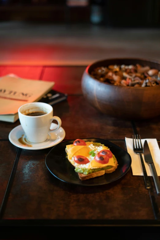 a breakfast food on a table and coffee on a plate