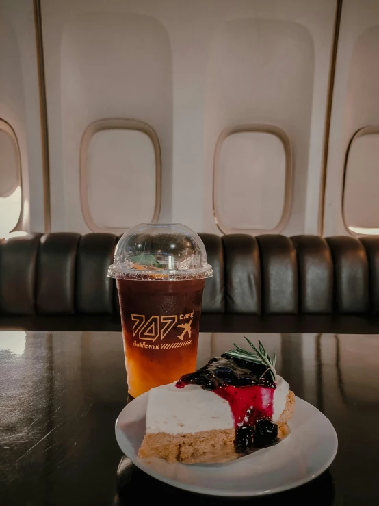 a white plate topped with cheesecake next to a drink