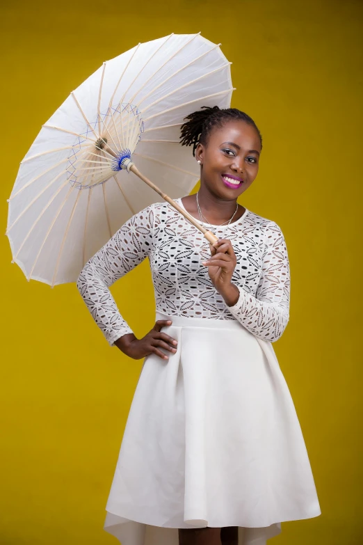 a black woman is holding a white umbrella