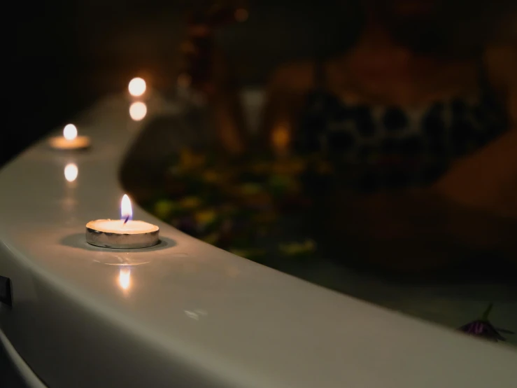 several lit candles on top of a table