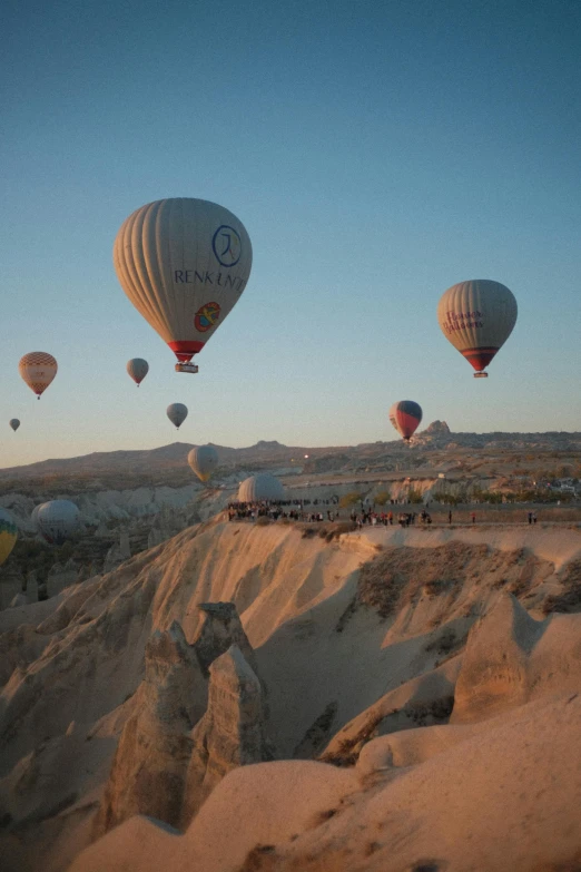  air balloons rising over the hills at sunrise