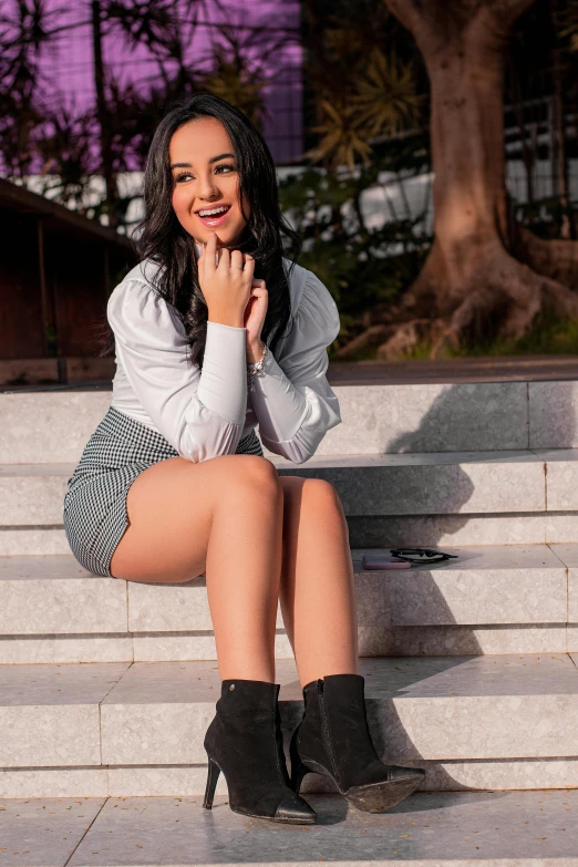 a young woman sitting on a set of steps