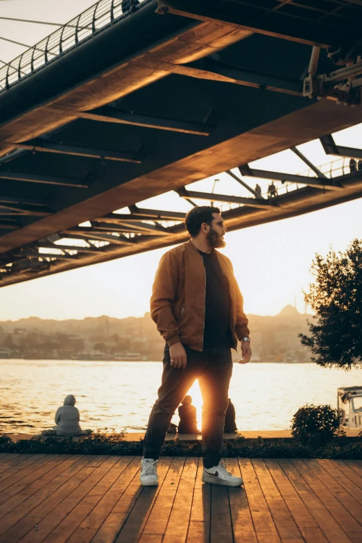 a man standing on top of a wooden floor next to water