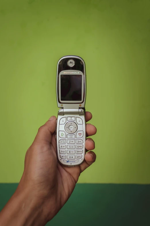 a small cell phone held in a hand