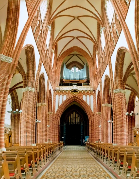 rows of wooden chairs are arranged within a cathedral