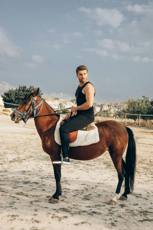 a woman riding on the back of a brown horse