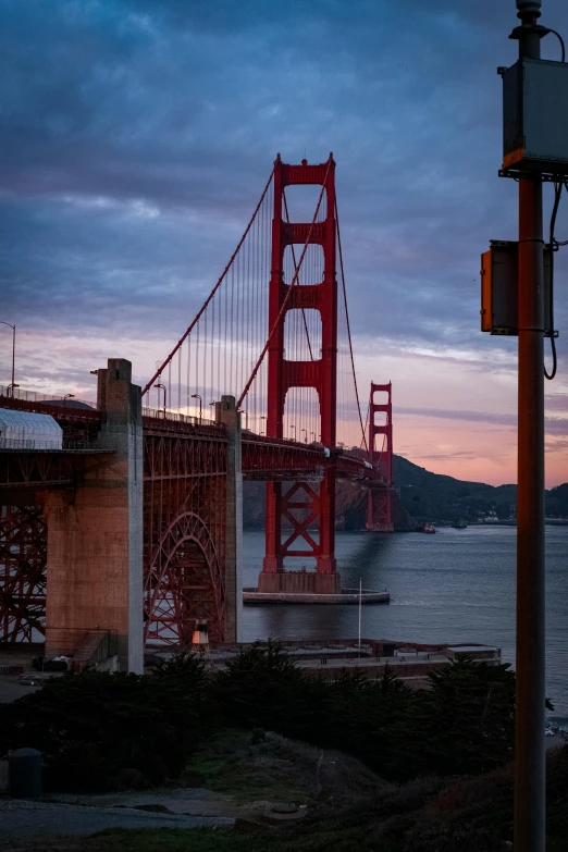 the golden gate bridge at sunset from across the water