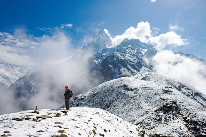 a man on top of a snow covered mountain