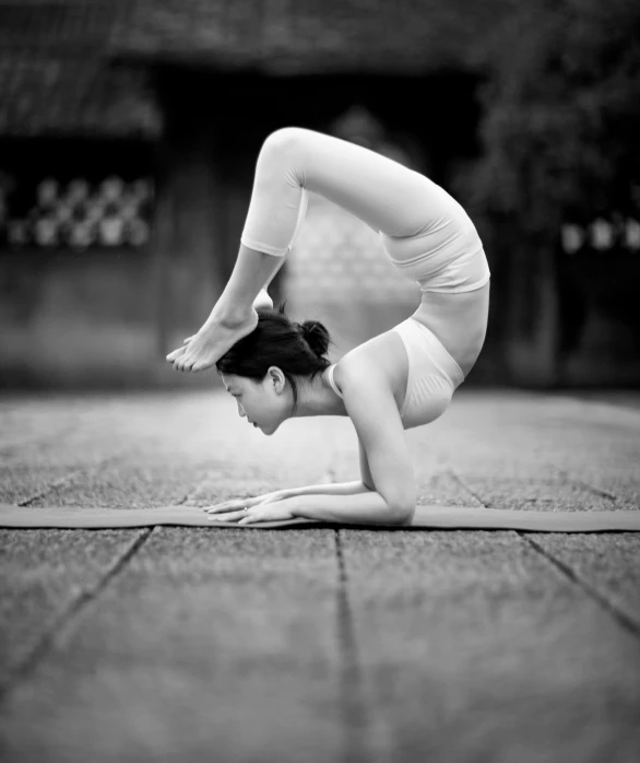 a woman in the shape of a cat performing a yoga pose