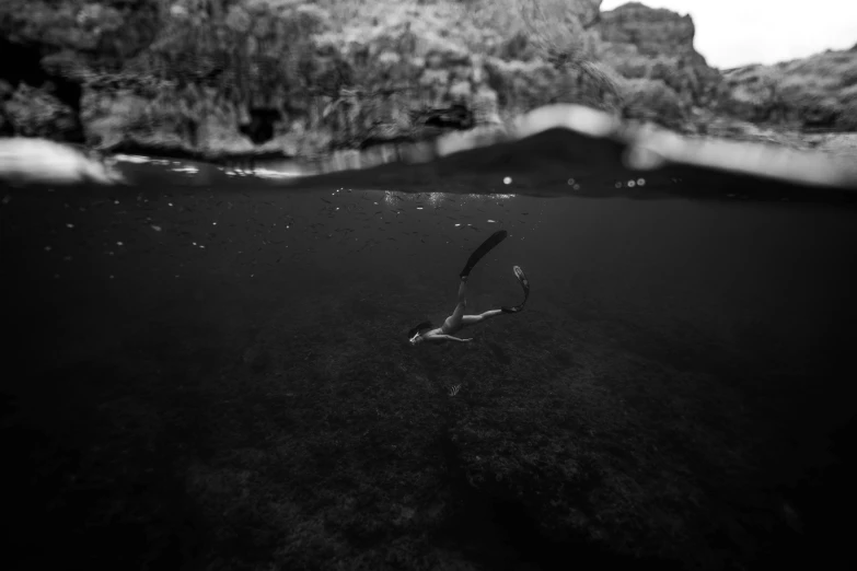 a scuba in a large lake with mountains in the background