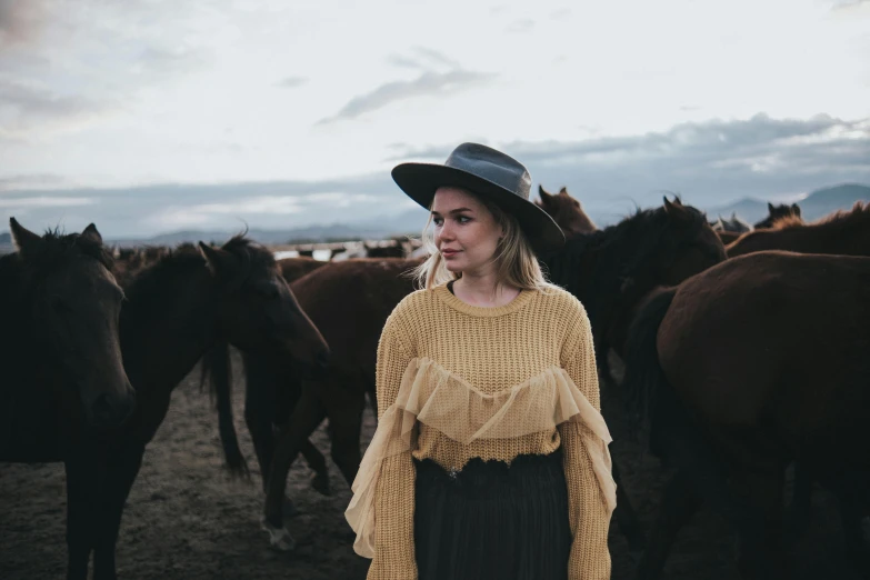 a young lady is posing for a po with horses