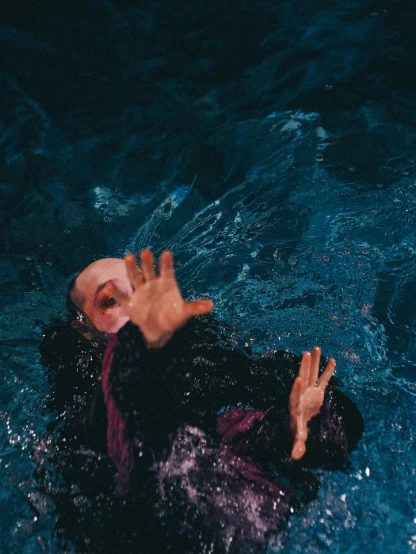 a person who is in the water with their hand up
