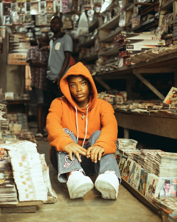 a young man sitting on the ground in a store