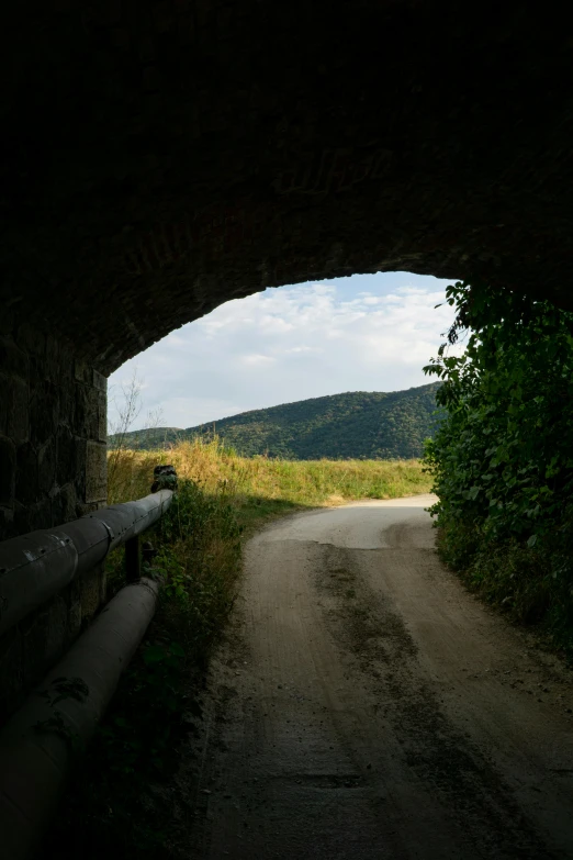 a road through the side of a small tunnel