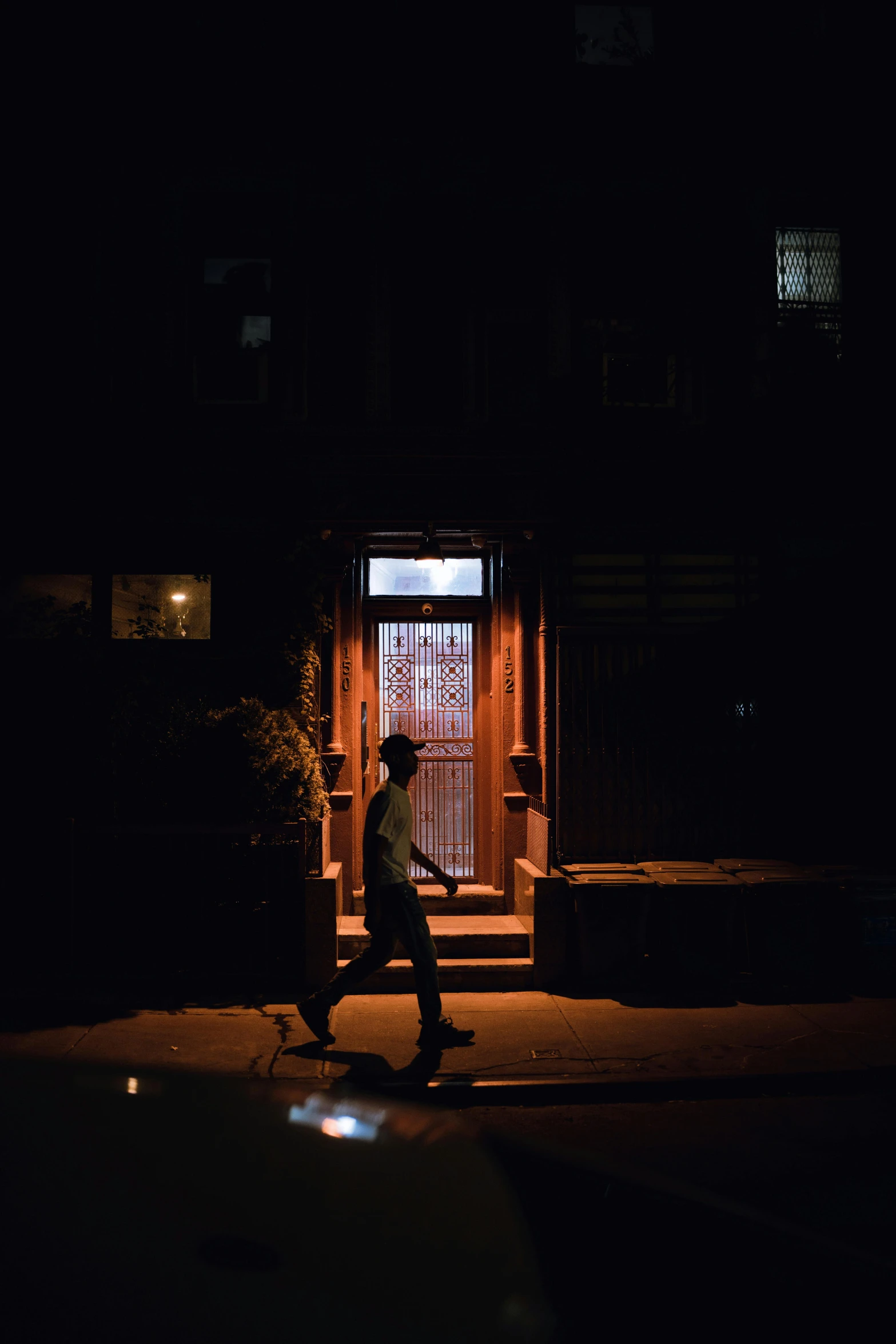 a man is skateboarding down the street in the dark