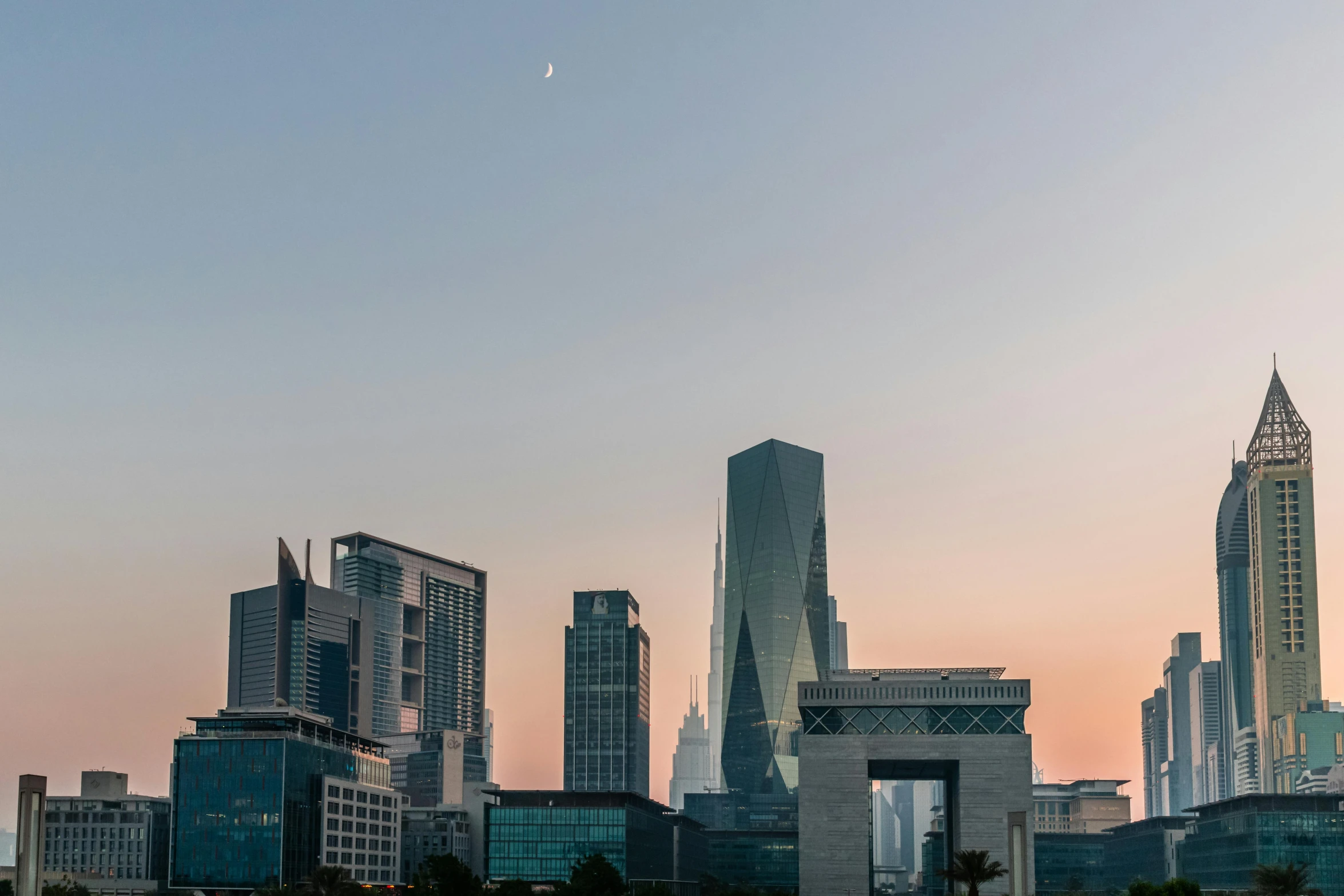 a view of buildings, skyscrs and an airplane in the sky