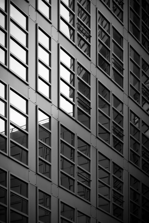 a building with some windows and an airplane flying by