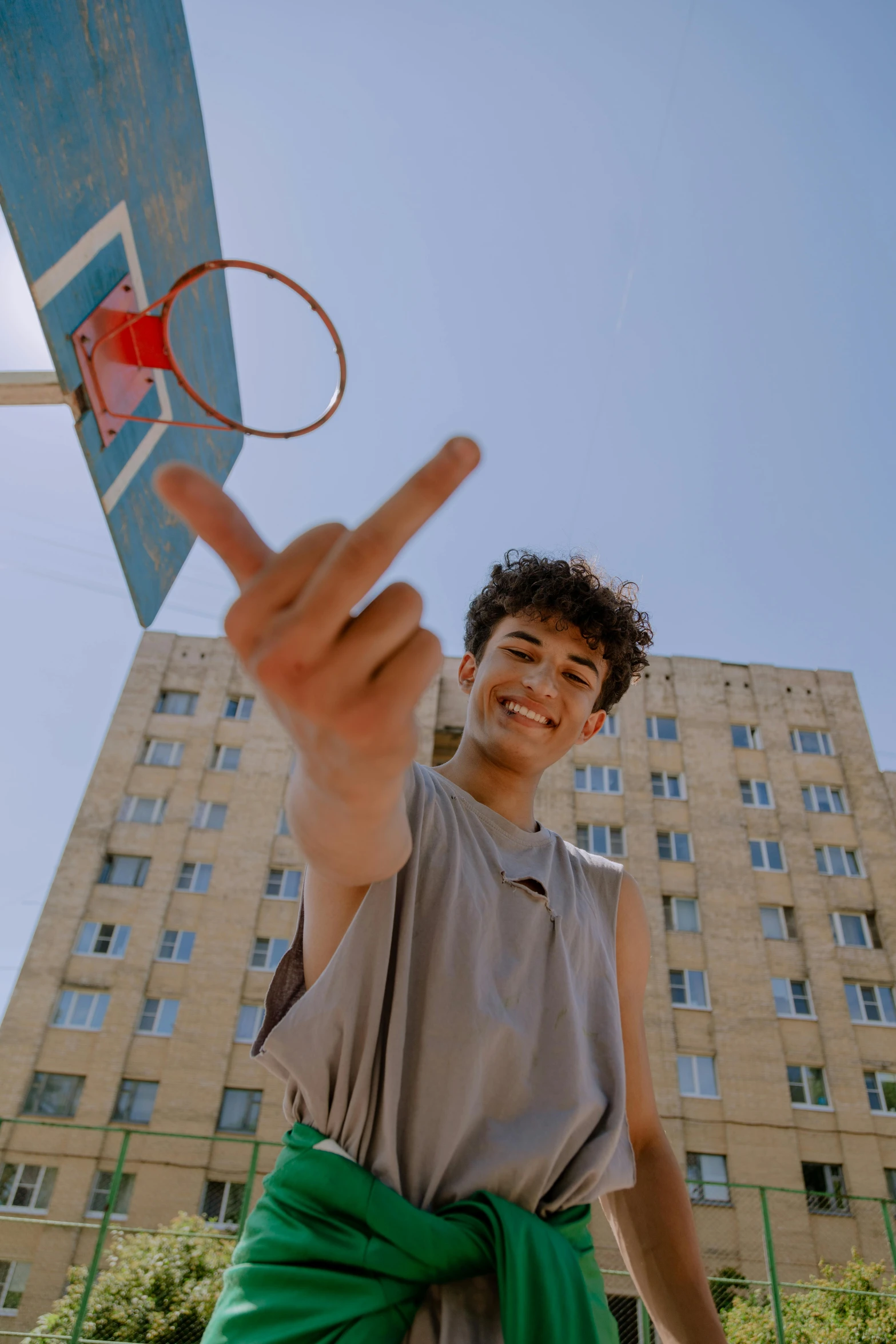 a person in front of a building holding a tennis racket