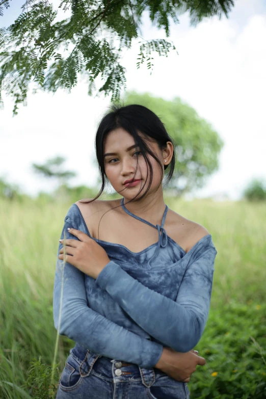 a woman is posing for a po in tall grass