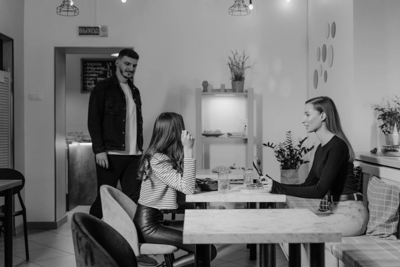 a black and white po of some people at a table