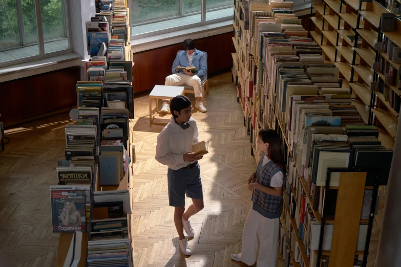 the two students are reading books together in the liry