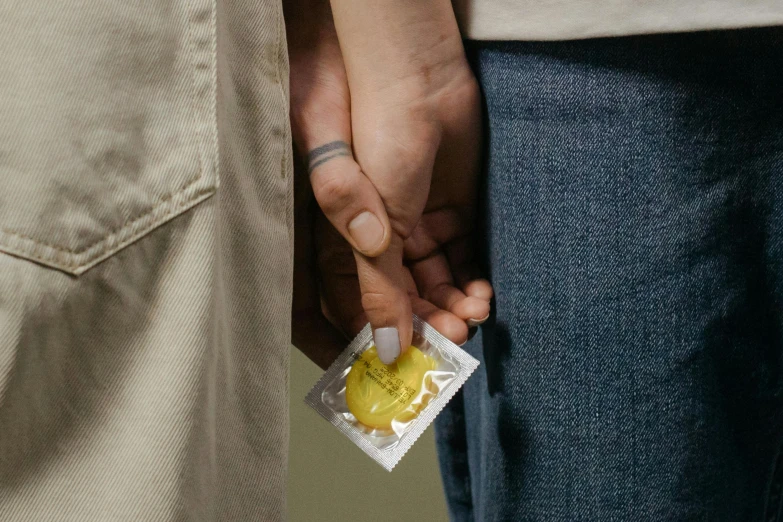 the couple hold a condom on their arm