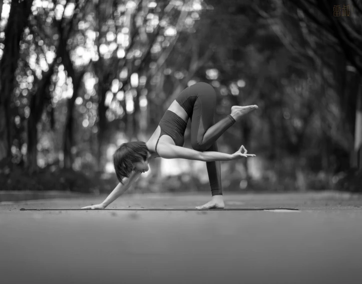 a woman is standing in a downward position