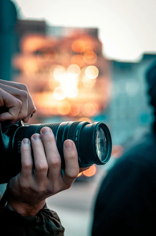 someone taking a po with their camera in front of some blurry lights