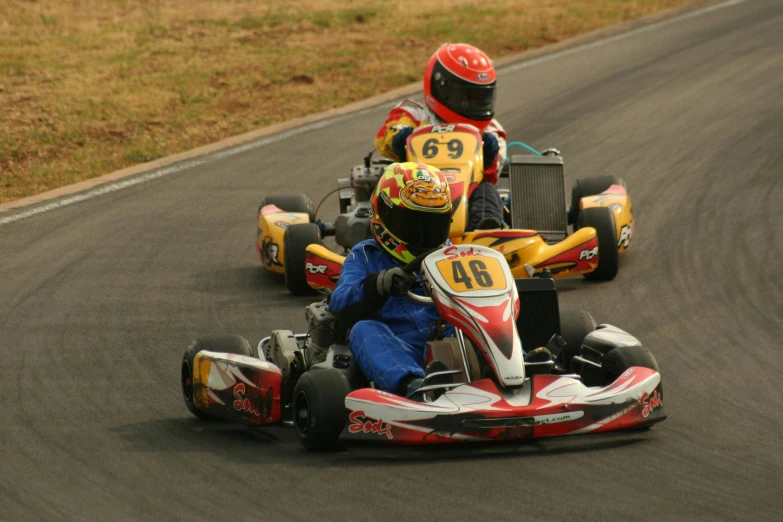 two people racing in kart style on a race track