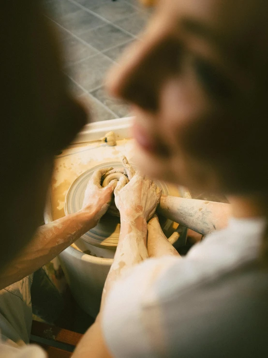 a man sitting on top of a white chair touching the end of a wheel