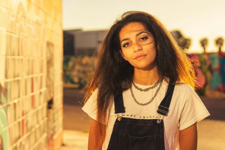 a girl standing next to a wall holding a string