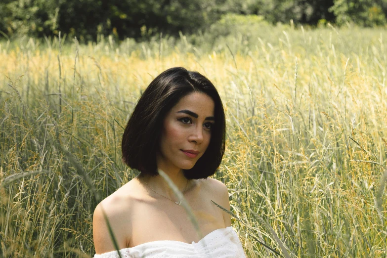 a woman posing for a po in tall grass