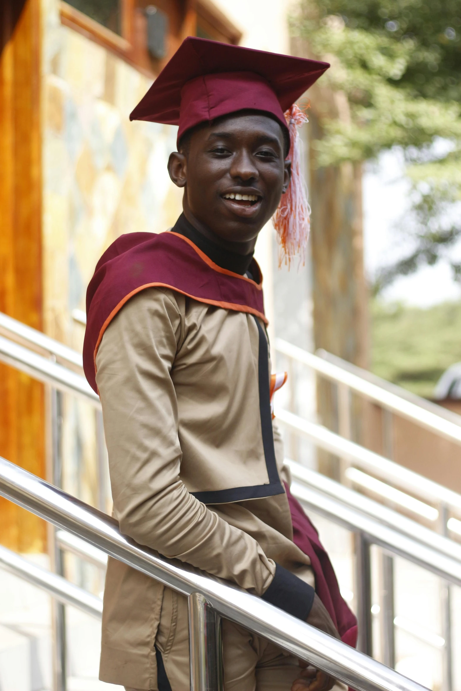 a boy in a graduation gown with a tie on