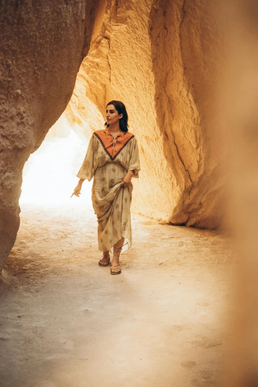 an old woman walking in the center of a canyon