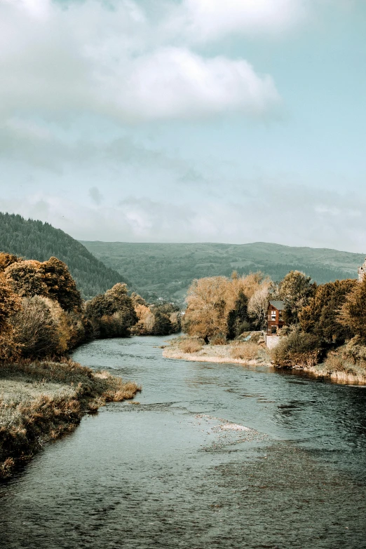 a wide creek runs through a rocky valley