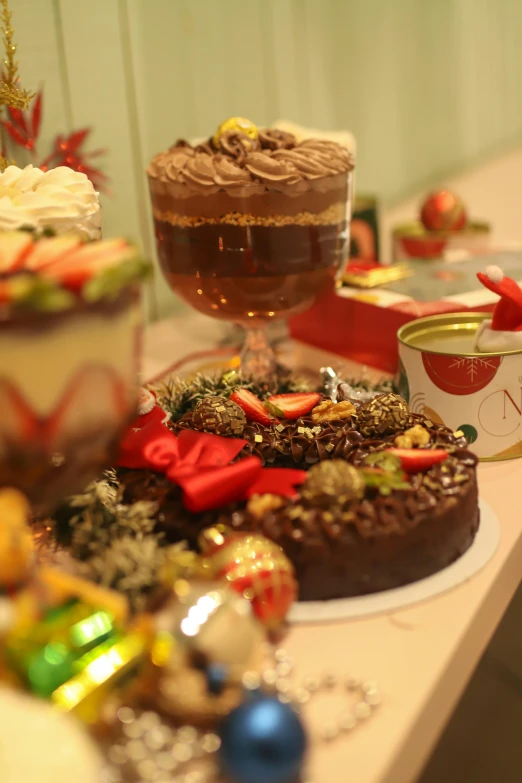 a table topped with cakes and a couple mugs