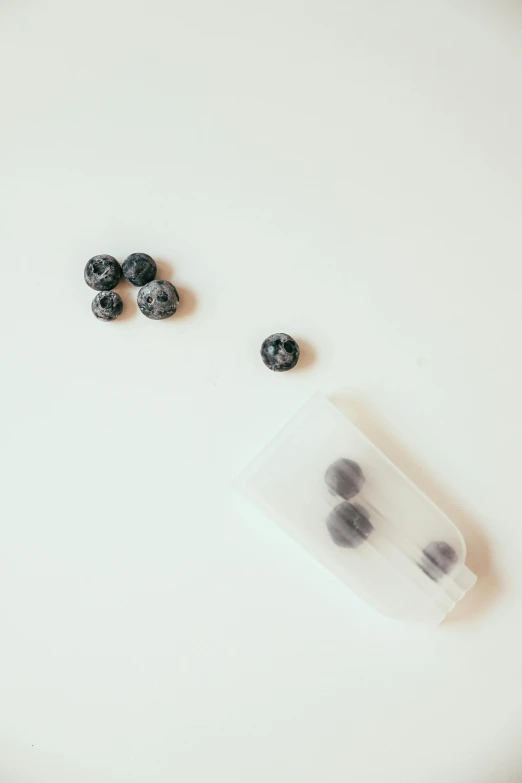 blackberries are sitting on the table next to an empty plastic bag