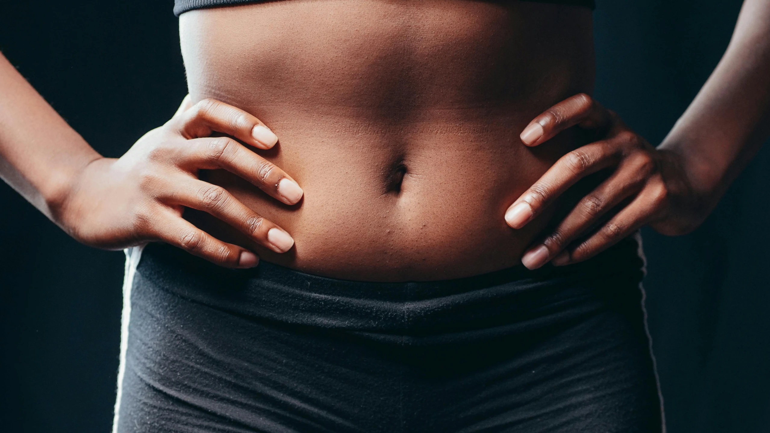 a woman is showing her stomach with  on